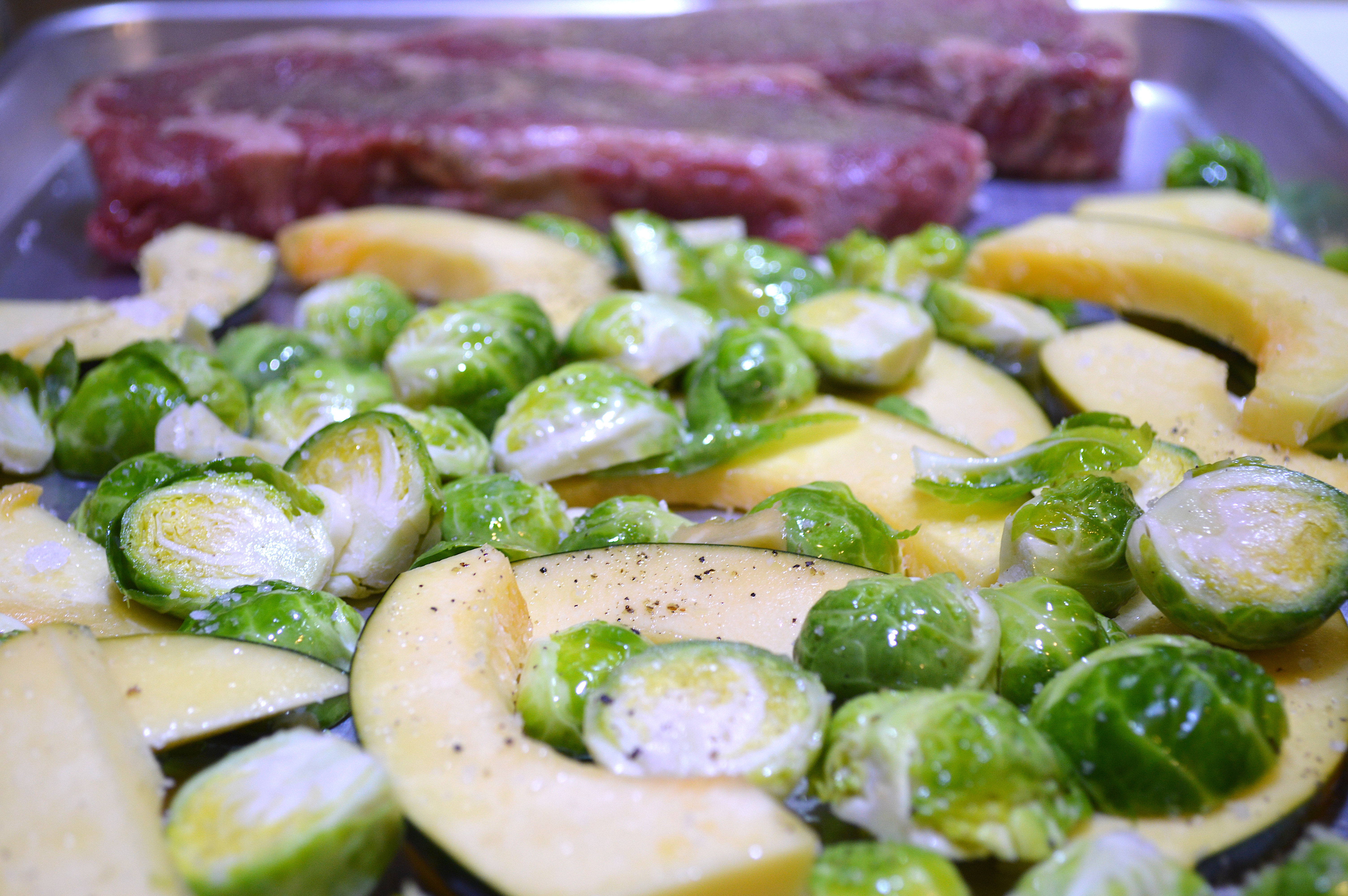 steak and veg on sheet pan, seasoned and ready to roast for Steak, acorn squash and brussels sprouts sheet pan meal