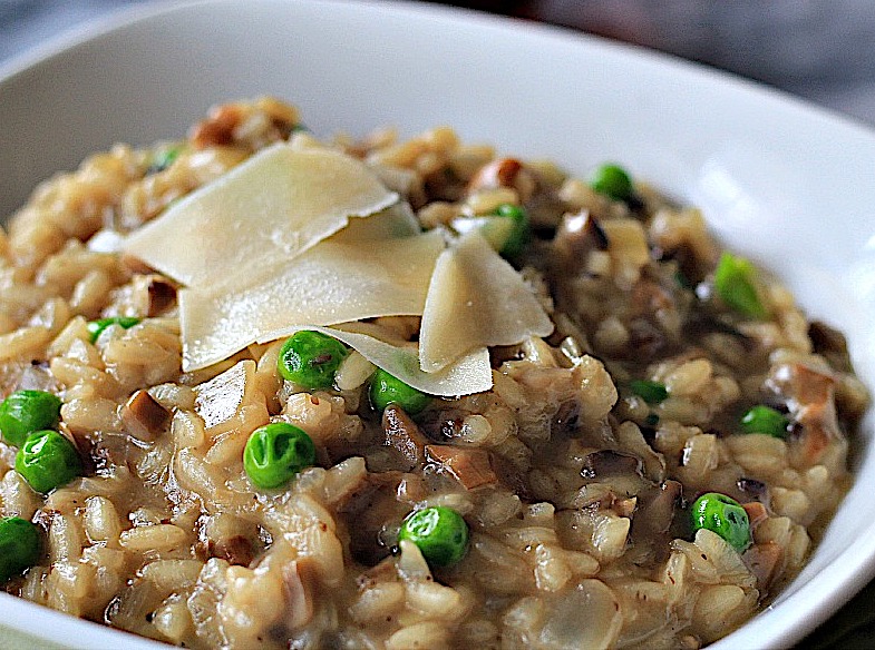 Italian Mushroom and Pea Risotto garnished with shaved Parmesan cheese